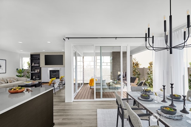 dining area with wood-type flooring and a chandelier