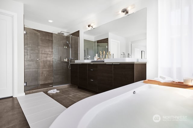 bathroom featuring a shower with door, vanity, and tile patterned floors