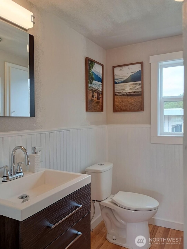 14607 Union Ave SW, Lakewood, WA 98498 - half bathroom with toilet, wood finished floors, wainscoting, and vanity