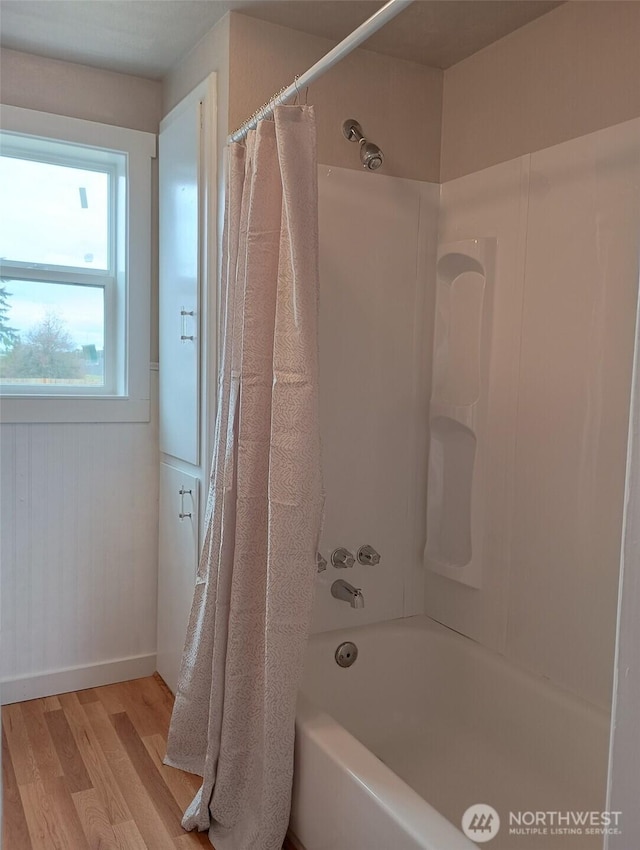 14607 Union Ave SW, Lakewood, WA 98498 - bathroom featuring wood finished floors, shower / bath combo, and baseboards