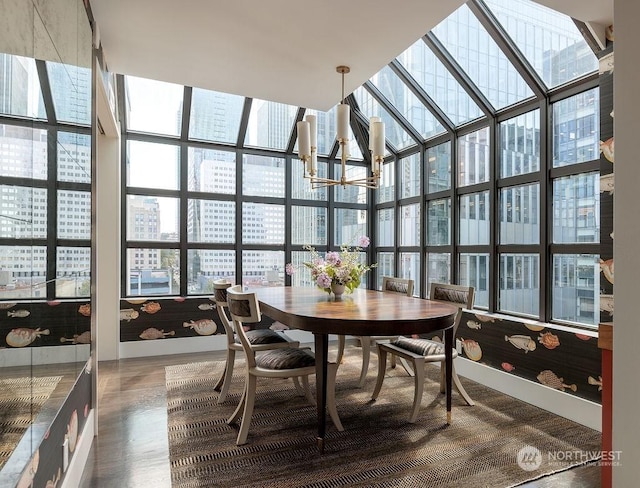 sunroom with plenty of natural light and a notable chandelier