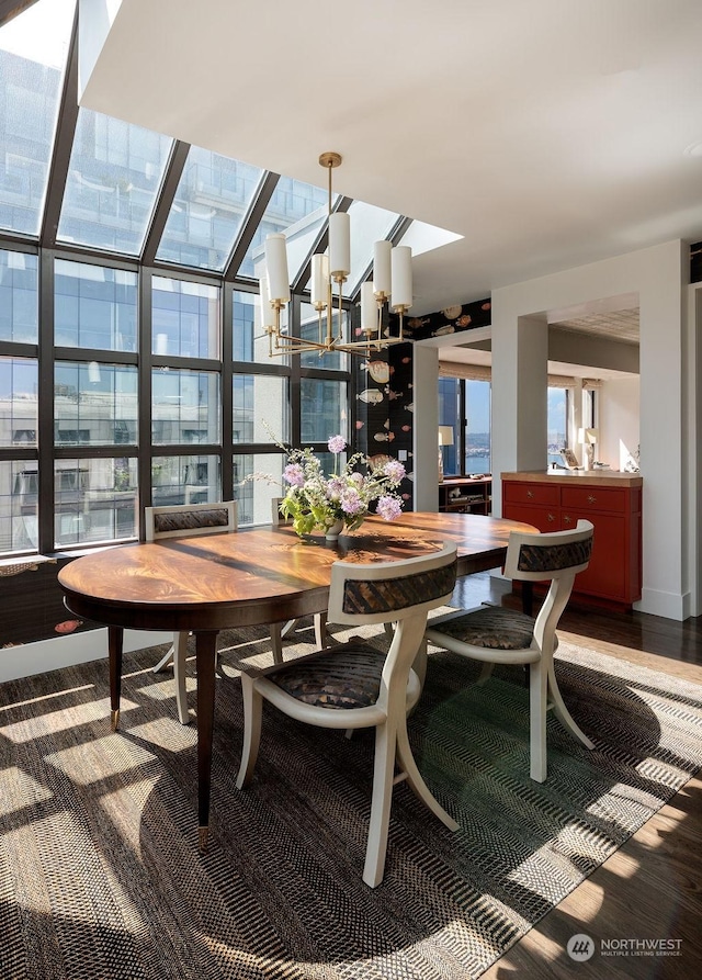 dining room with hardwood / wood-style floors, a notable chandelier, and floor to ceiling windows