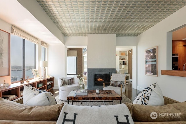 living room featuring brick ceiling and a water view