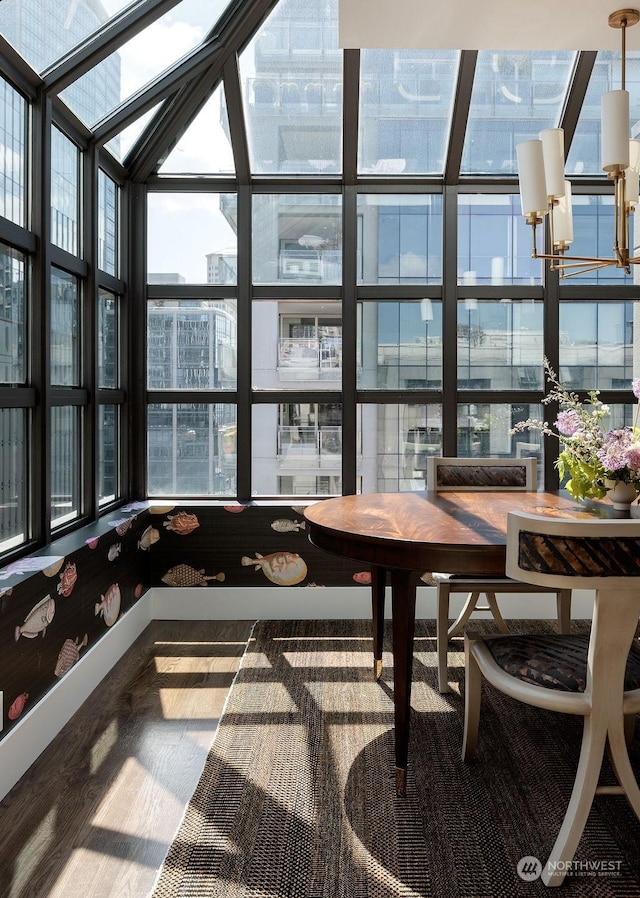 sunroom / solarium featuring a chandelier and plenty of natural light