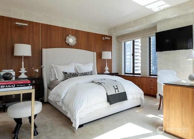 bedroom featuring wood walls