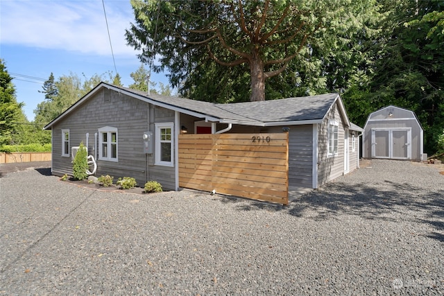 view of front of home with a shed