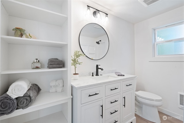 bathroom with hardwood / wood-style flooring, vanity, and toilet