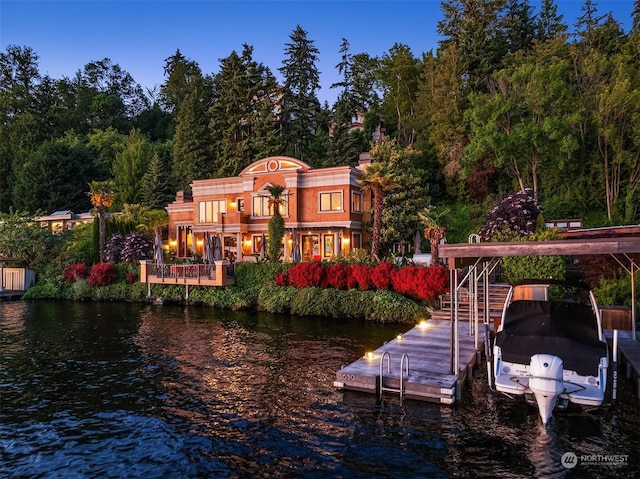 rear view of house featuring a water view