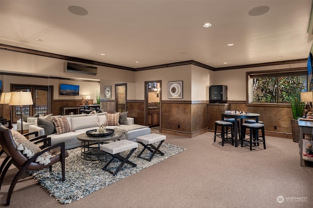 carpeted living room featuring an AC wall unit, ornamental molding, and wooden walls