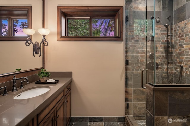 bathroom featuring vanity and a shower with shower door