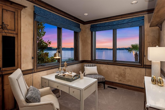 sitting room featuring crown molding, a water view, and carpet floors