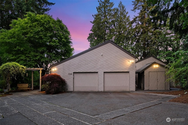 view of garage at dusk