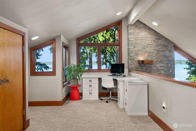 carpeted home office featuring lofted ceiling with beams