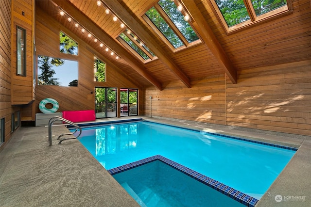 view of swimming pool with an indoor hot tub