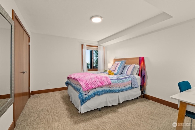 bedroom featuring light carpet and a closet