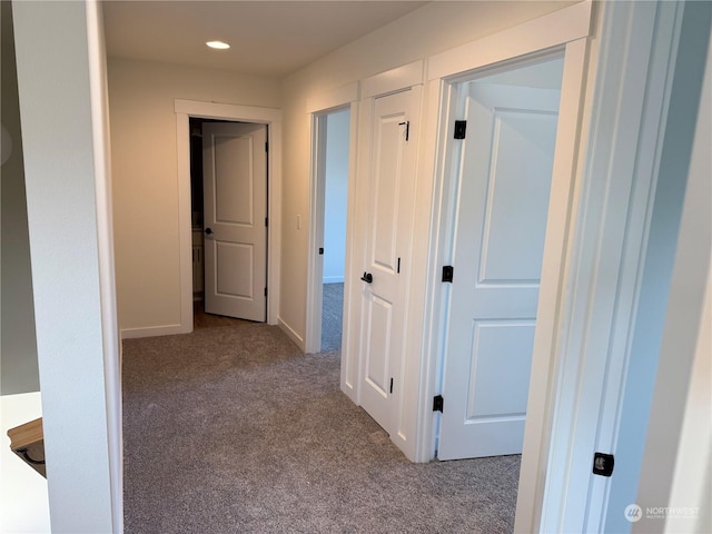 hallway featuring light carpet