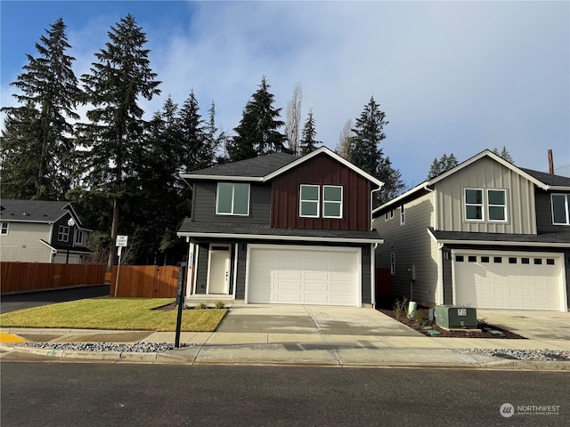 front of property featuring a front yard, central AC, and a garage