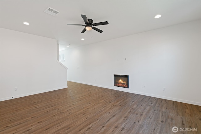 11118 NE 91st Ave, Vancouver, WA 98662 - unfurnished living room featuring visible vents, baseboards, a glass covered fireplace, wood finished floors, and a ceiling fan