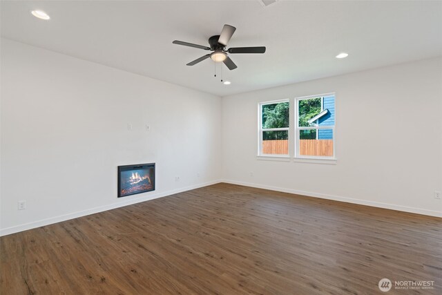 11118 NE 91st Ave, Vancouver, WA 98662 - spare room featuring dark wood-style floors, recessed lighting, baseboards, and a glass covered fireplace