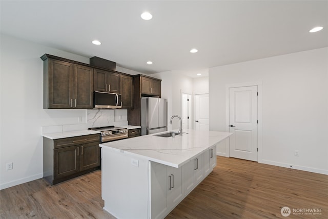 11118 NE 91st Ave, Vancouver, WA 98662 - kitchen with a sink, appliances with stainless steel finishes, dark brown cabinets, wood finished floors, and a kitchen island with sink
