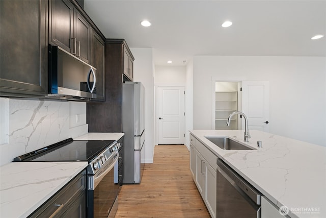 11118 NE 91st Ave, Vancouver, WA 98662 - kitchen with light wood finished floors, recessed lighting, a sink, tasteful backsplash, and appliances with stainless steel finishes