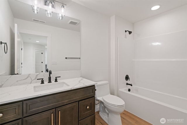 11118 NE 91st Ave, Vancouver, WA 98662 - bathroom featuring visible vents, toilet, wood finished floors, vanity, and bathtub / shower combination