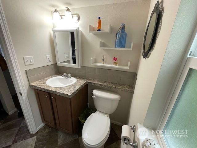 bathroom featuring vanity and toilet