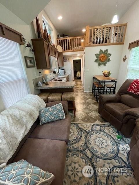 living room featuring high vaulted ceiling