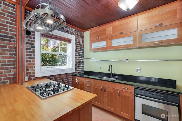 kitchen featuring sink, stainless steel appliances, wood counters, brick wall, and wood ceiling