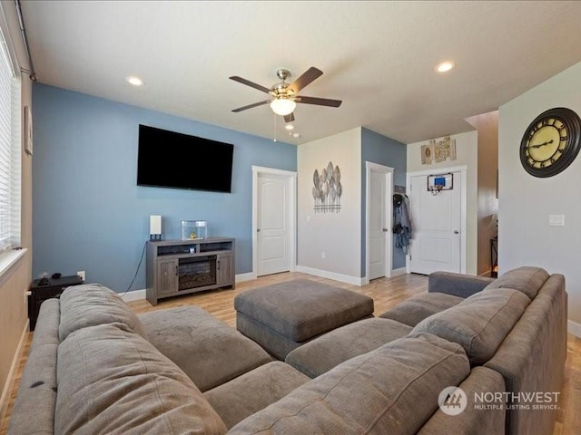 living room with ceiling fan and light hardwood / wood-style flooring