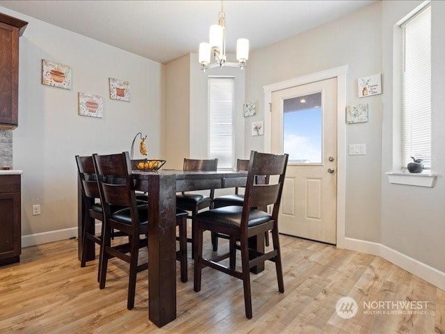 dining room with a chandelier and light hardwood / wood-style floors