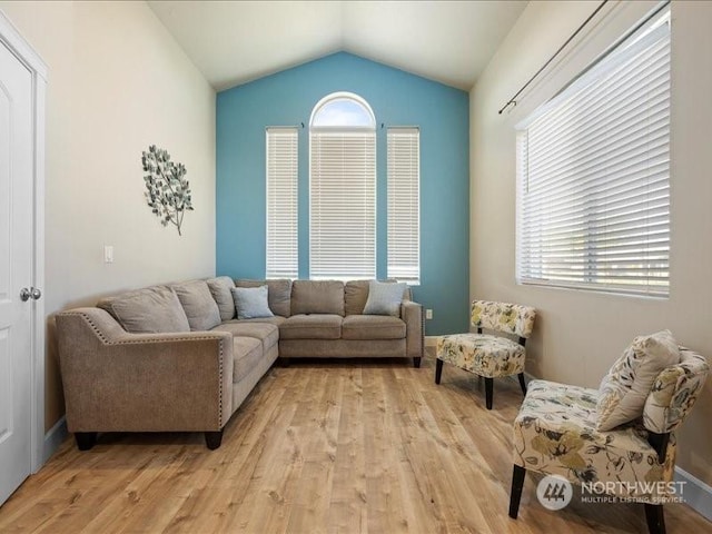 living room featuring light hardwood / wood-style flooring and lofted ceiling