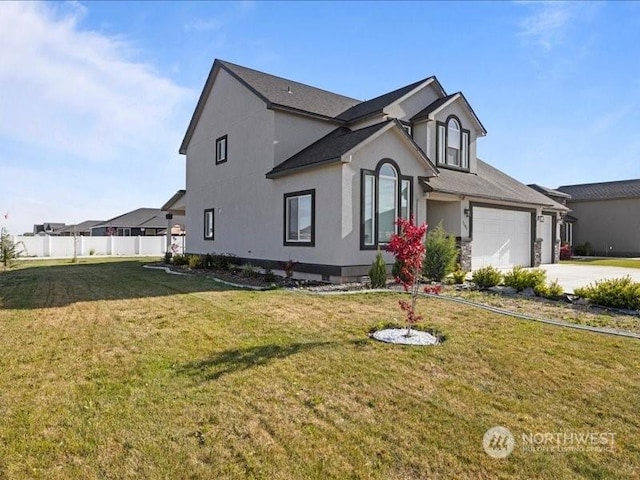 view of front of property with a front yard and a garage