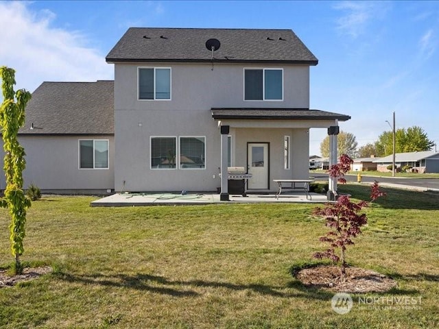 back of house with a patio and a yard