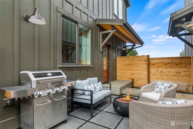 view of patio / terrace with area for grilling and an outdoor living space with a fire pit