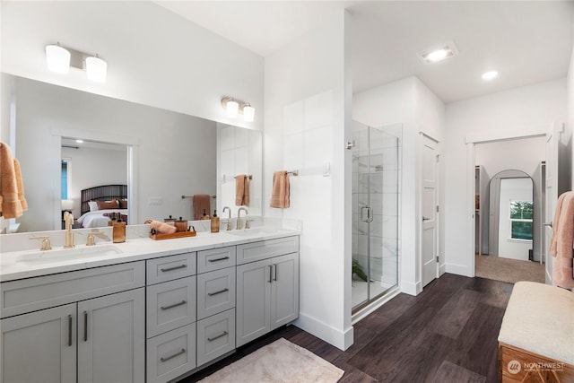 bathroom featuring a shower with door, vanity, and hardwood / wood-style flooring