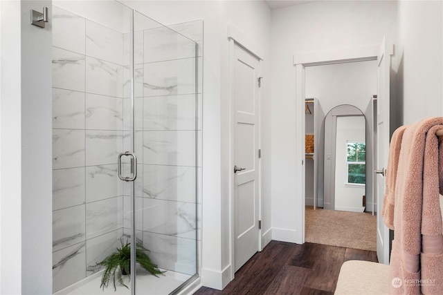 bathroom featuring walk in shower and hardwood / wood-style flooring