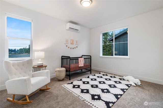 bedroom featuring a wall mounted AC, carpet, and a nursery area