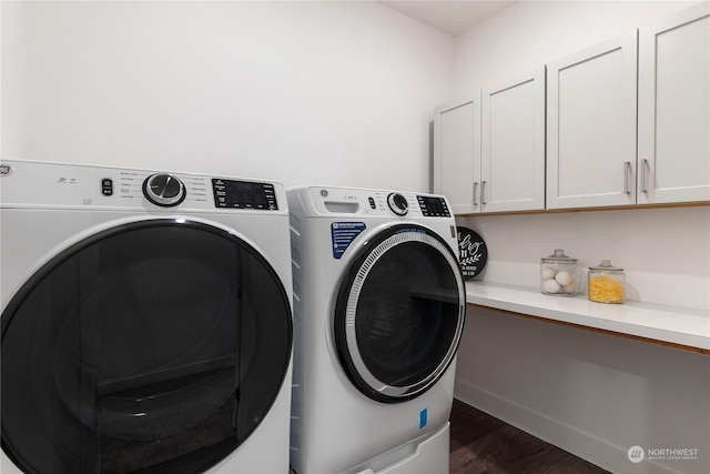 laundry room with separate washer and dryer, cabinets, and dark hardwood / wood-style floors