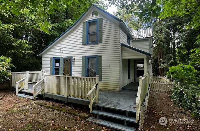 back of property with a wooden deck