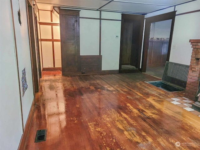 interior space featuring a fireplace and dark wood-type flooring