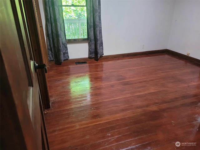 spare room featuring dark hardwood / wood-style floors