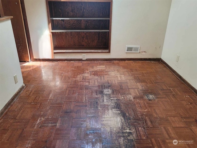 unfurnished room featuring dark parquet floors