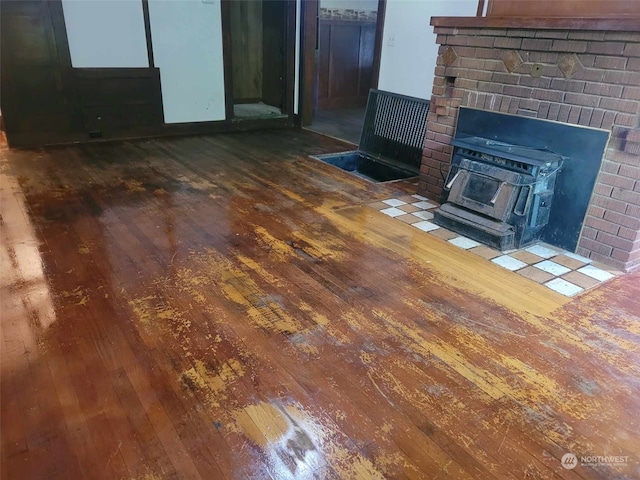 interior space featuring hardwood / wood-style floors and a wood stove