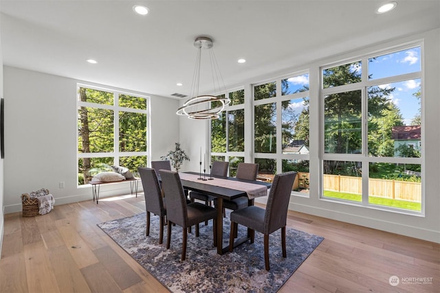 dining room with a chandelier and light hardwood / wood-style flooring