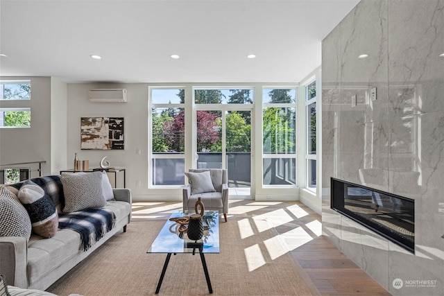 living room with an AC wall unit and a fireplace