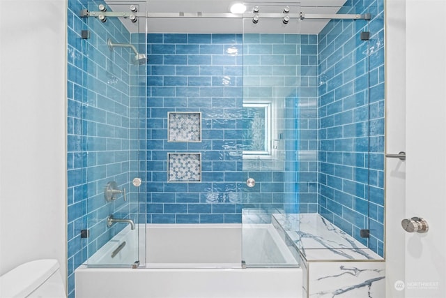 bathroom featuring toilet and enclosed tub / shower combo