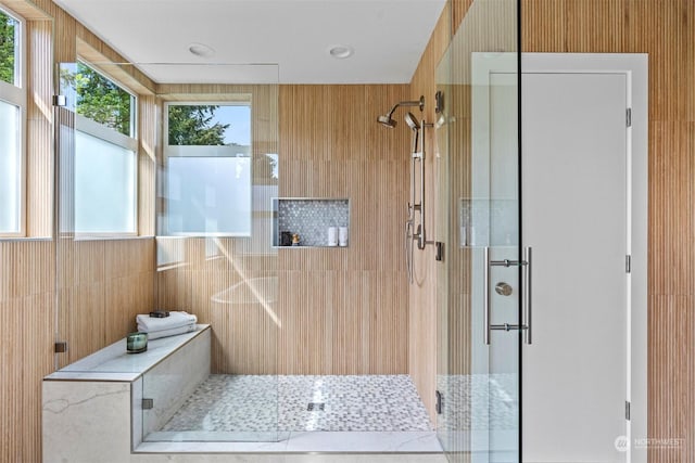 bathroom featuring a shower with shower door