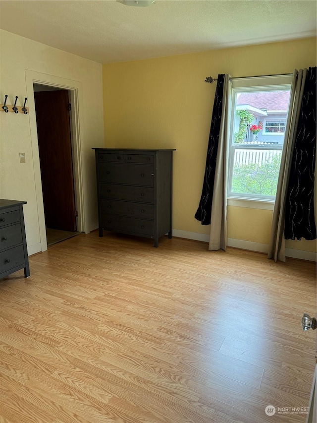 unfurnished room with light hardwood / wood-style floors