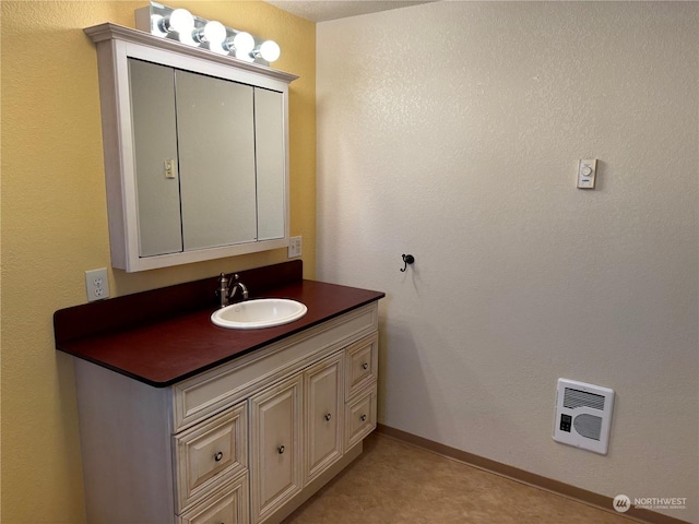 bathroom featuring vanity and heating unit